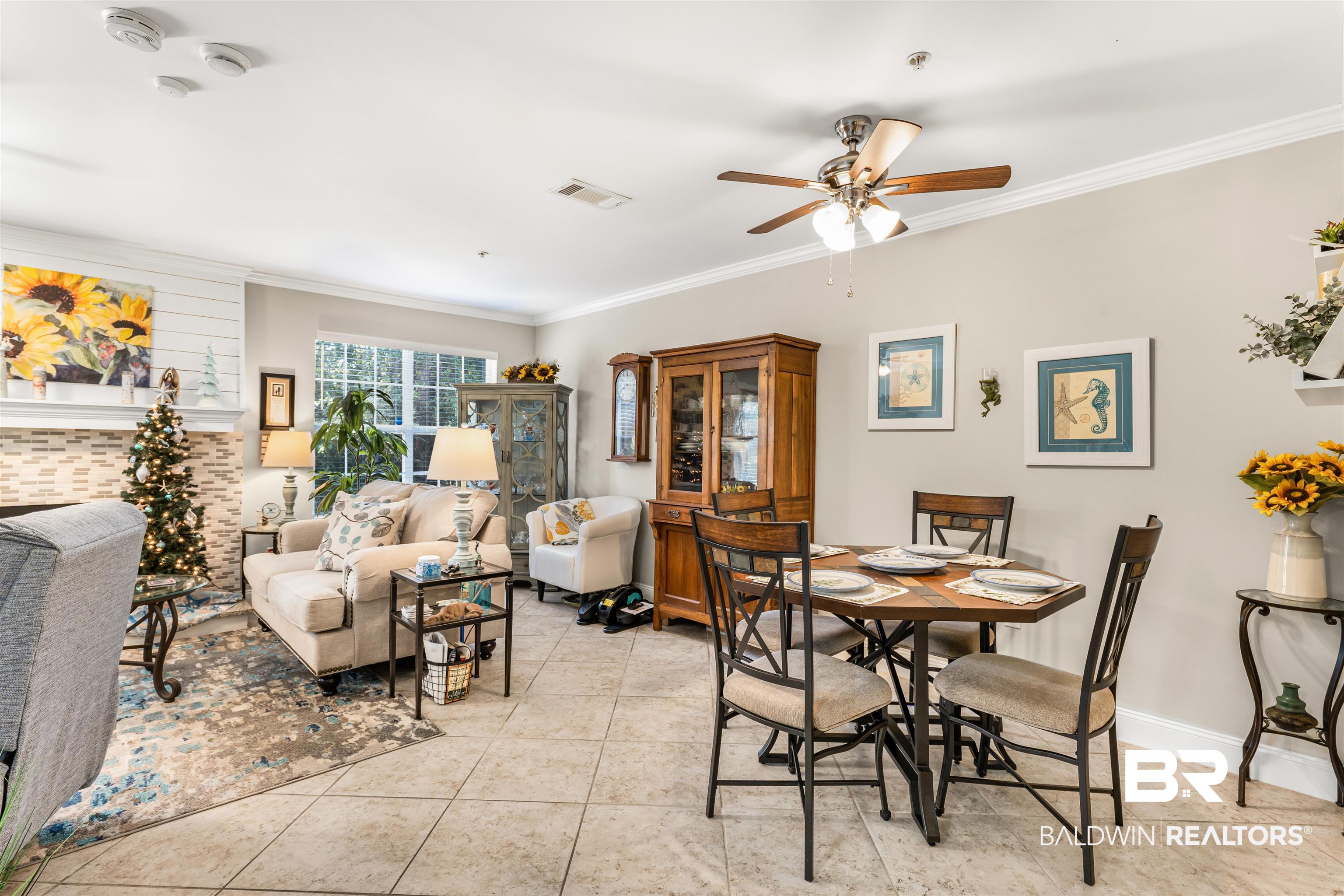 1517 Regency Road, Unit 68 Gulf Shores, AL 36542 - Photo 12 of 43 Dining room with light tile patterned floors, ceiling fan, and crown molding