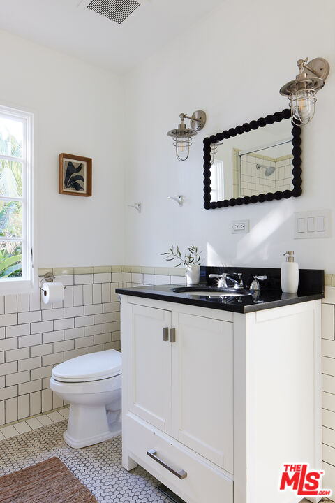 6637 Zumirez Drive Malibu, CA 90265 - Photo 12 of 29 a bathroom with a sink a toilet and a mirror