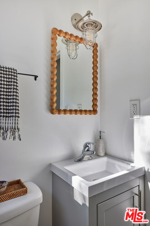 6637 Zumirez Drive Malibu, CA 90265 - Photo 16 of 29 a bathroom with a sink a vanity and mirror
