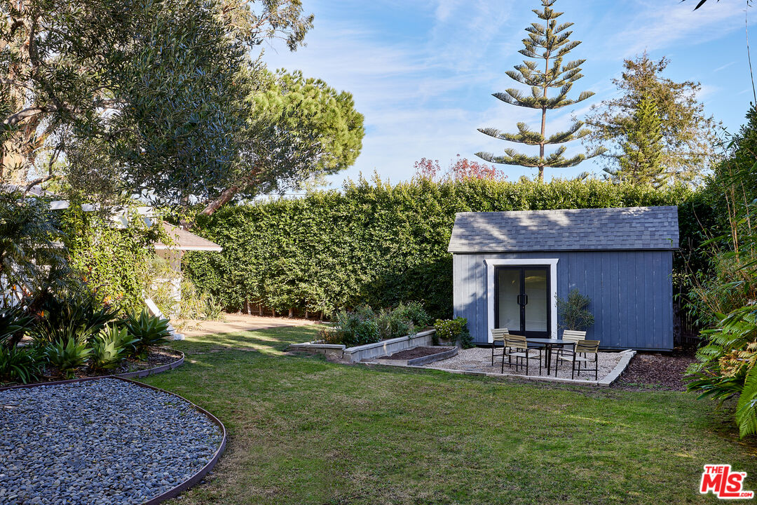 6637 Zumirez Drive Malibu, CA 90265 - Photo 24 of 29 a view of a patio with table and chairs potted plants and large tree