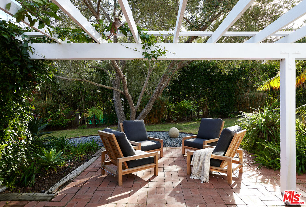 6637 Zumirez Drive Malibu, CA 90265 - Photo 5 of 29 a view of backyard with outdoor seating and green space