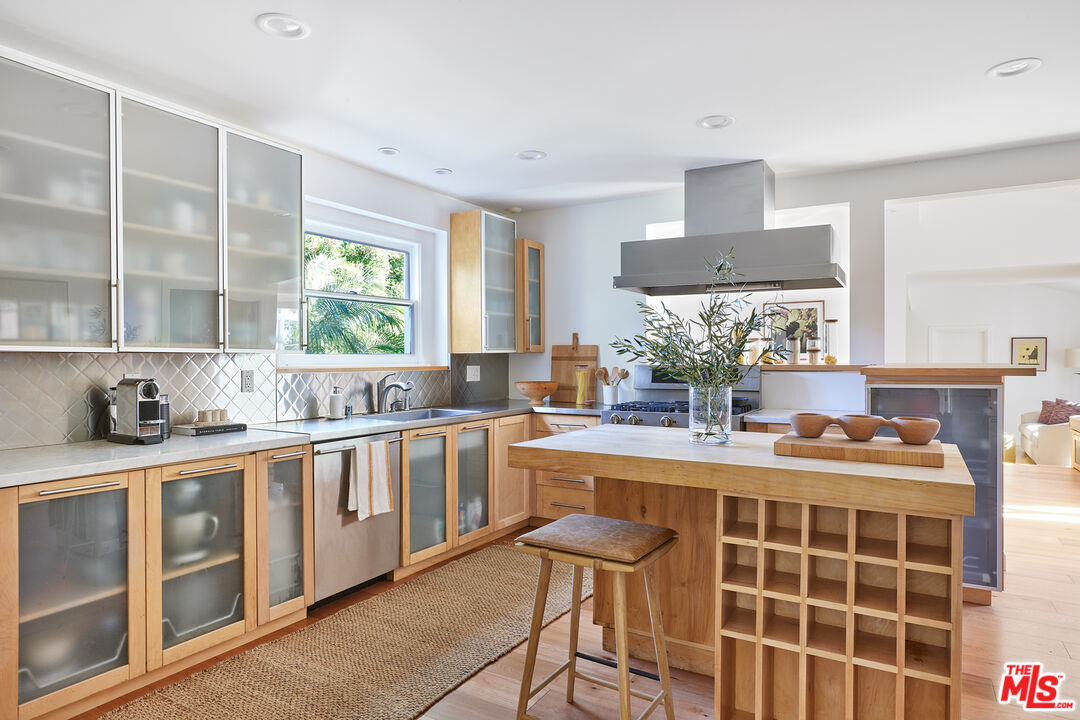 6637 Zumirez Drive Malibu, CA 90265 - Photo 7 of 29 a kitchen with stainless steel appliances granite countertop a stove a sink and a refrigerator