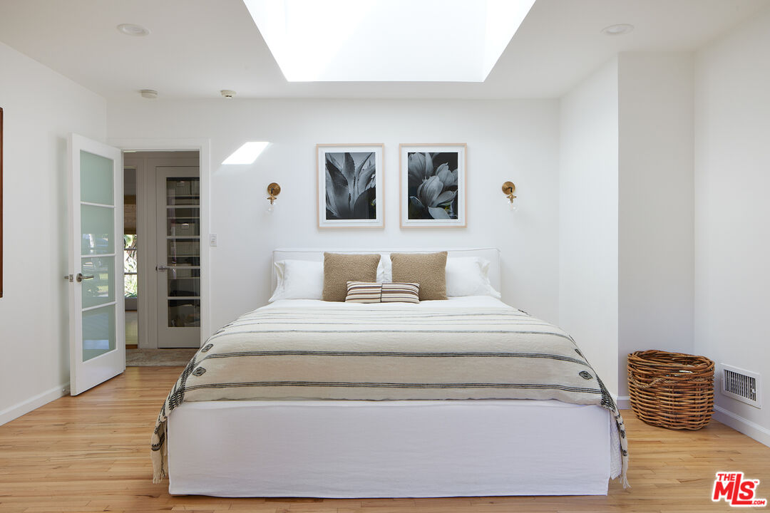6637 Zumirez Drive Malibu, CA 90265 - Photo 8 of 29 a spacious bedroom with a bed and wooden floor