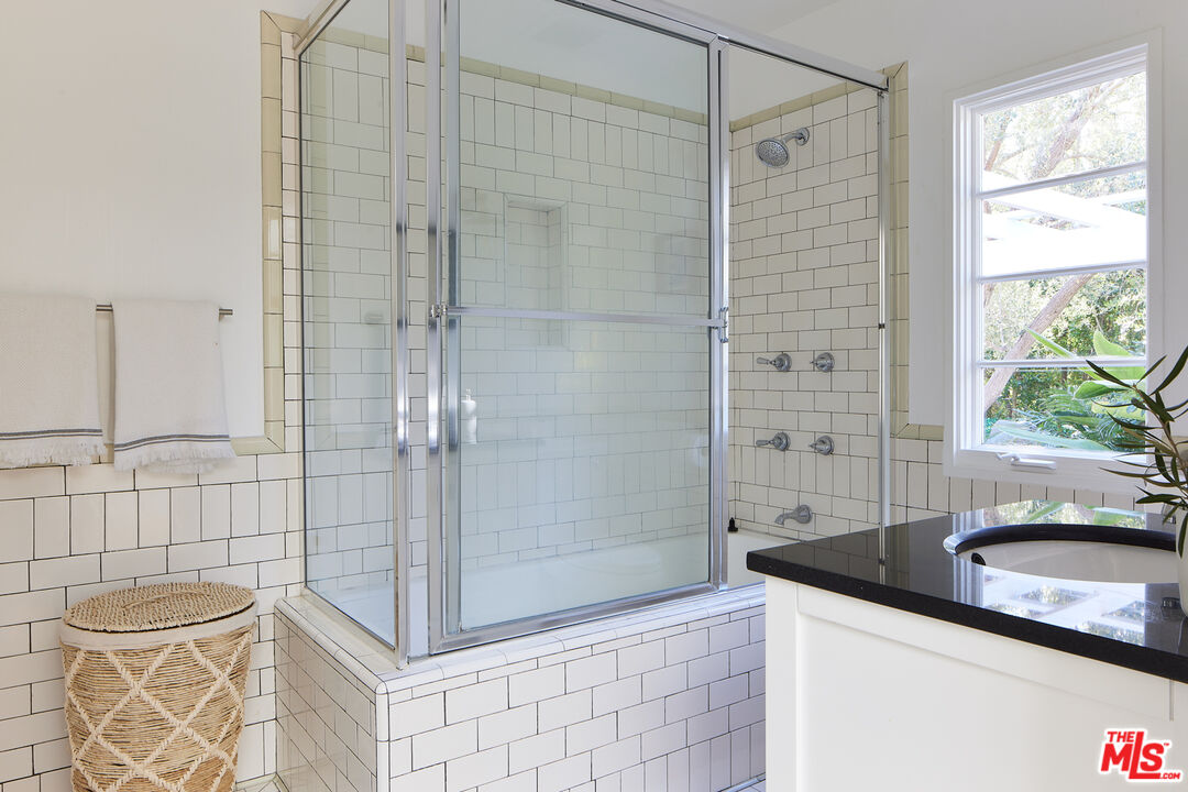 6637 Zumirez Drive Malibu, CA 90265 - Photo 10 of 29 a bathroom with a granite countertop sink a toilet and shower