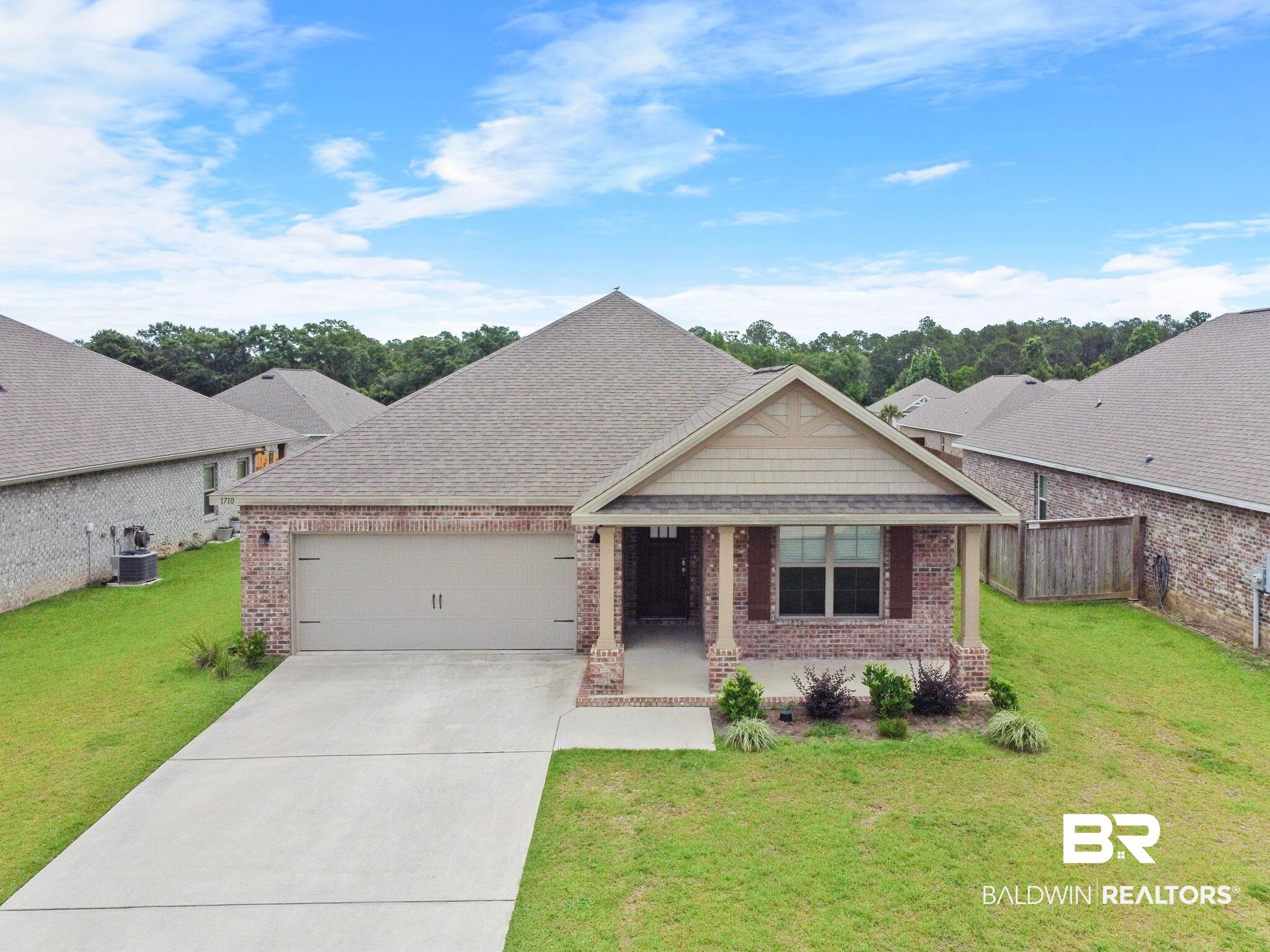1710 Grouse Street Foley, AL 36535 - Photo 4 of 76 Brick facade single-story residence featuring a two-car garage, covered entry, and front landscaping