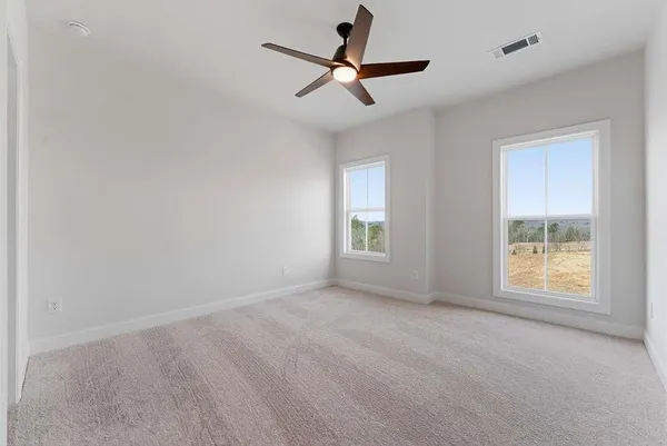 a view of room with window and ceiling fan