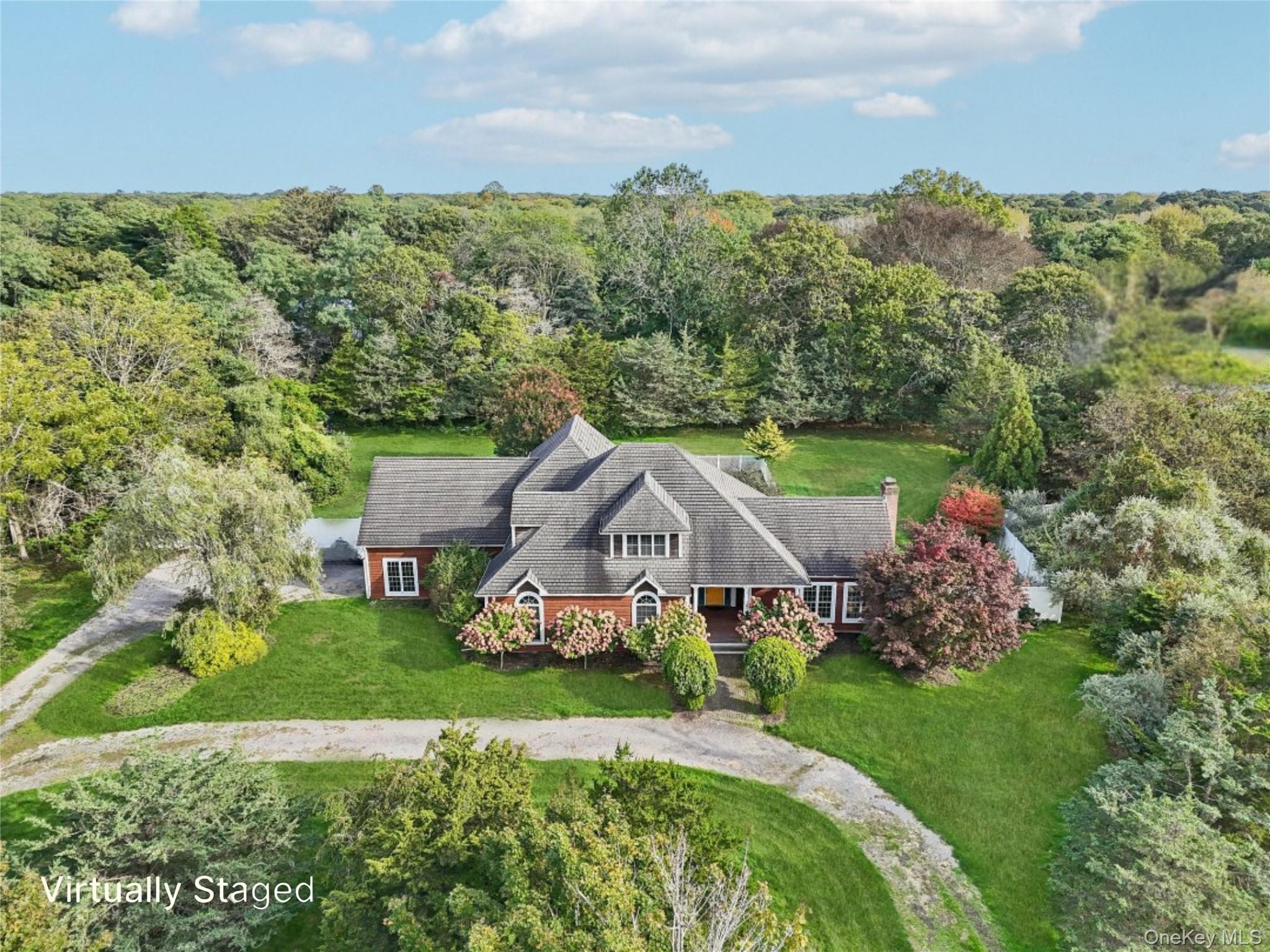 12 Laila Lane Remsenburg, NY 11960 - Photo 1 of 50 aerial view of a house with a big yard and large trees