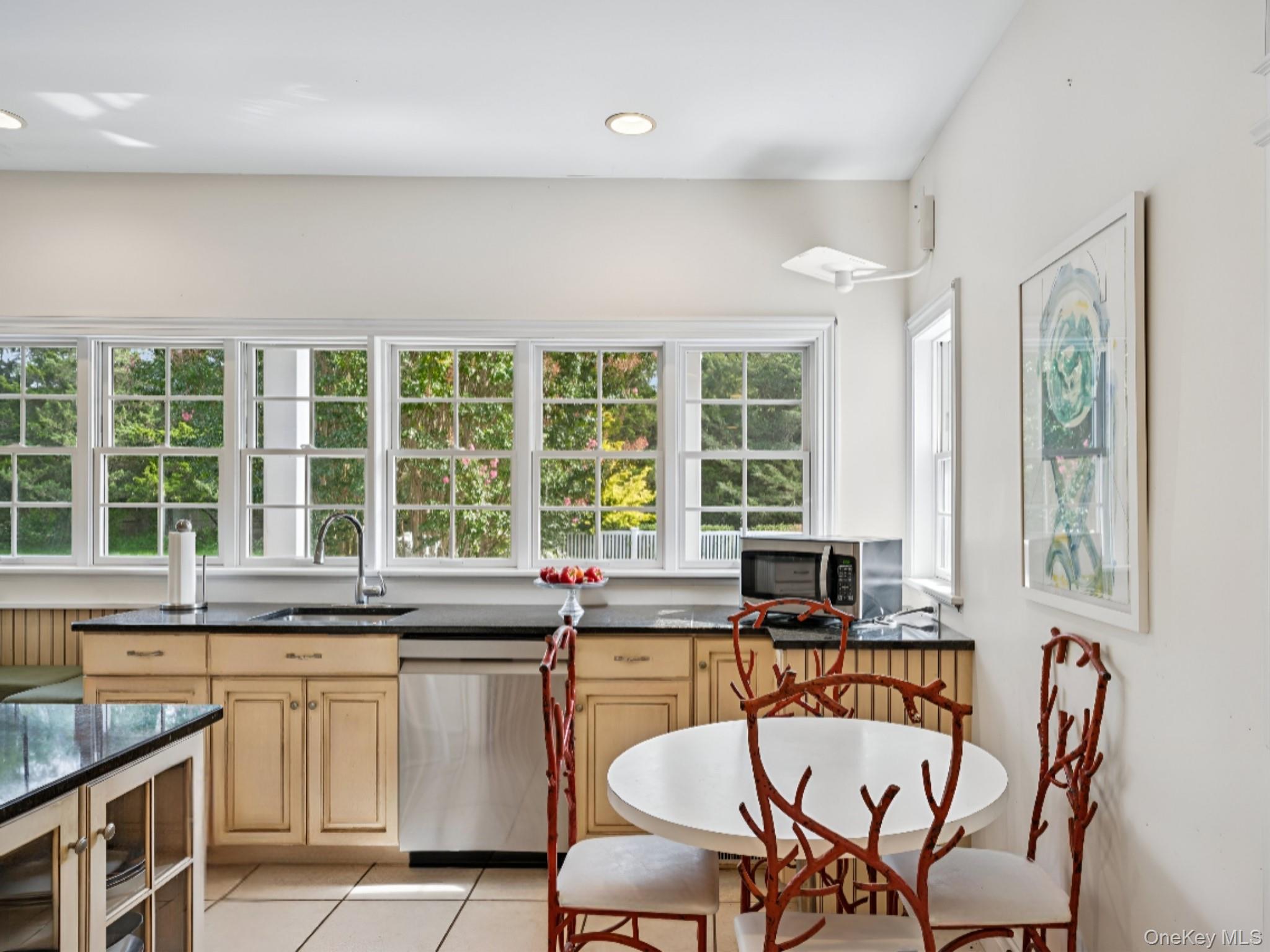 12 Laila Lane Remsenburg, NY 11960 - Photo 16 of 50 a kitchen with a stove a sink and a dining table chair
