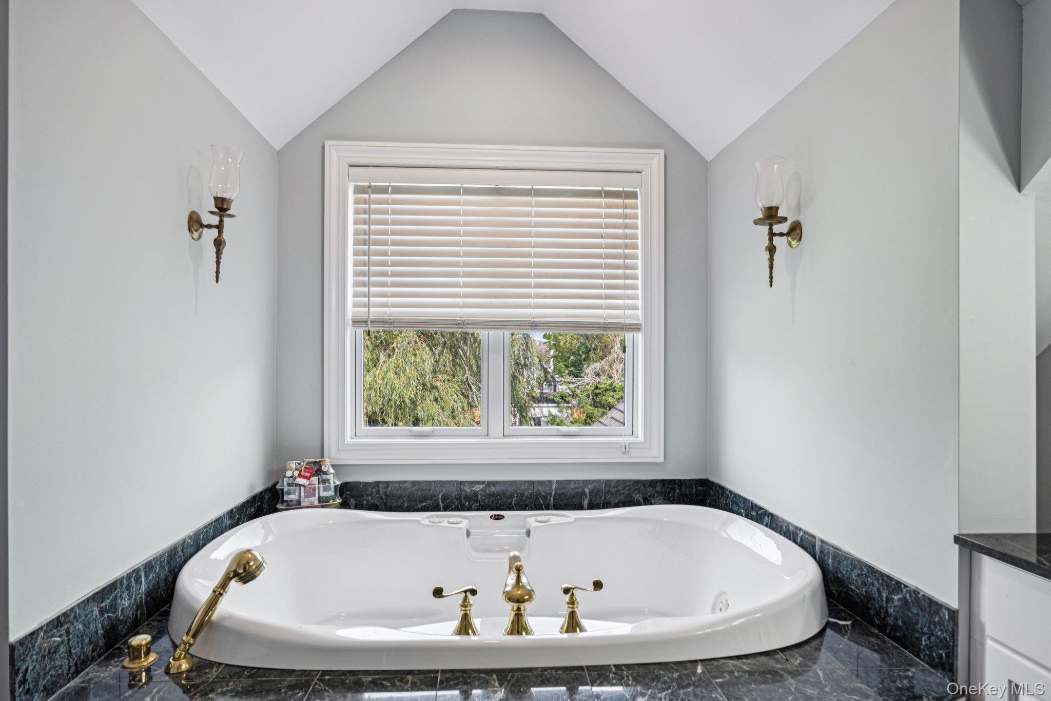 12 Laila Lane Remsenburg, NY 11960 - Photo 32 of 49 a white bath tub sitting in a bathroom next to a window