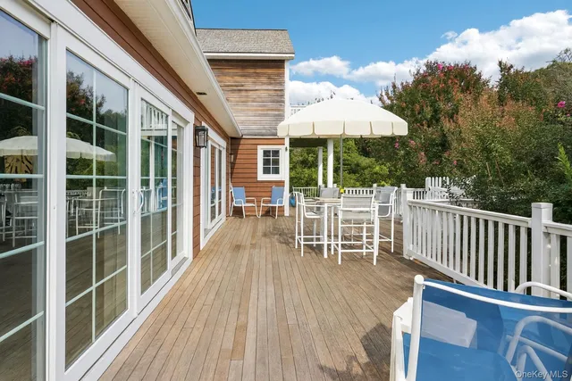 a view of a chair and table on the wooden deck