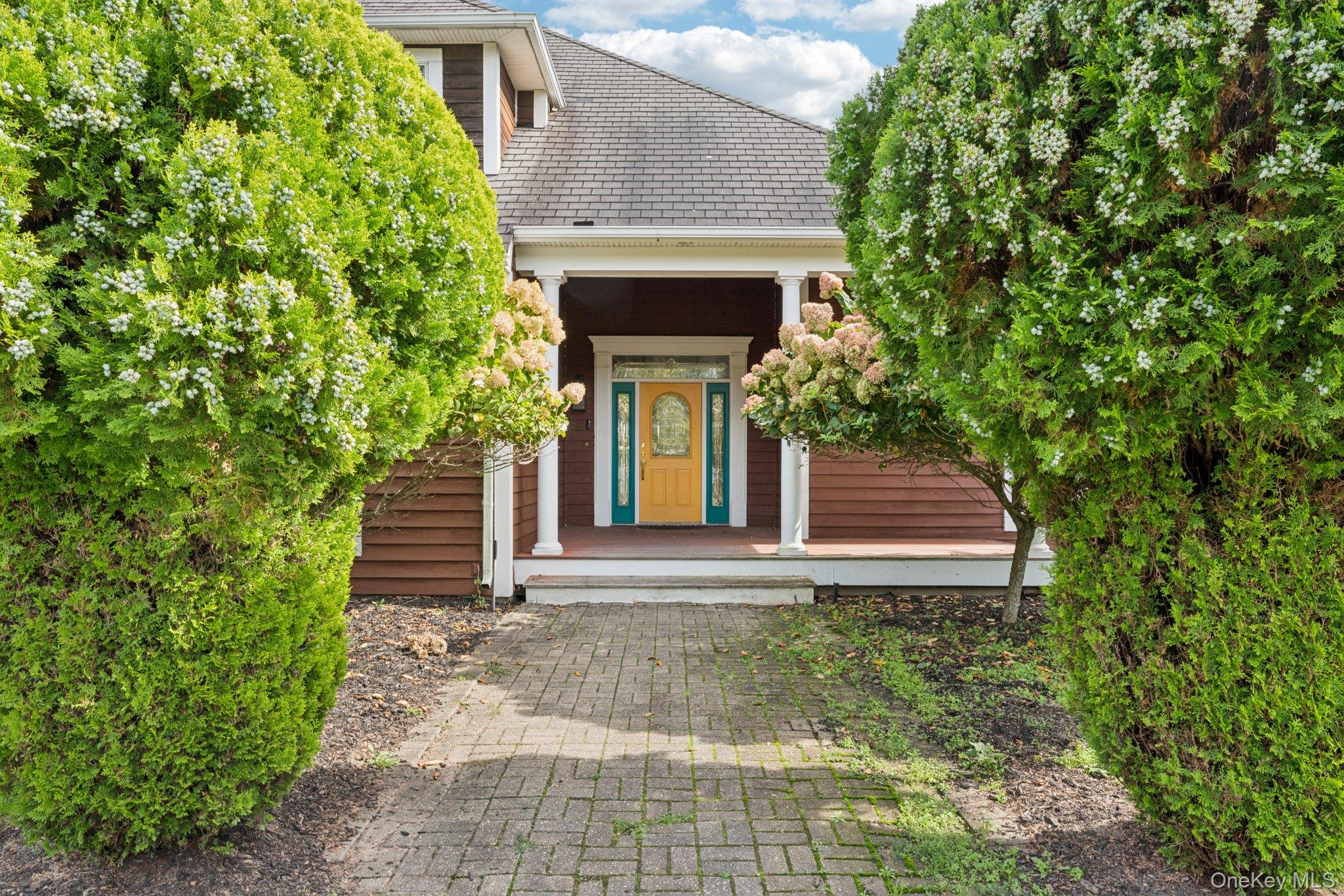 12 Laila Lane Remsenburg, NY 11960 - Photo 4 of 49 a small garden in the corner of a house