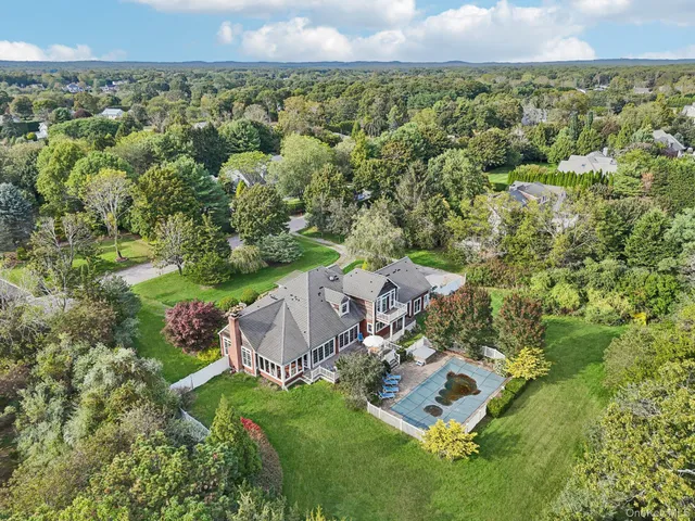 an aerial view of a house with a yard
