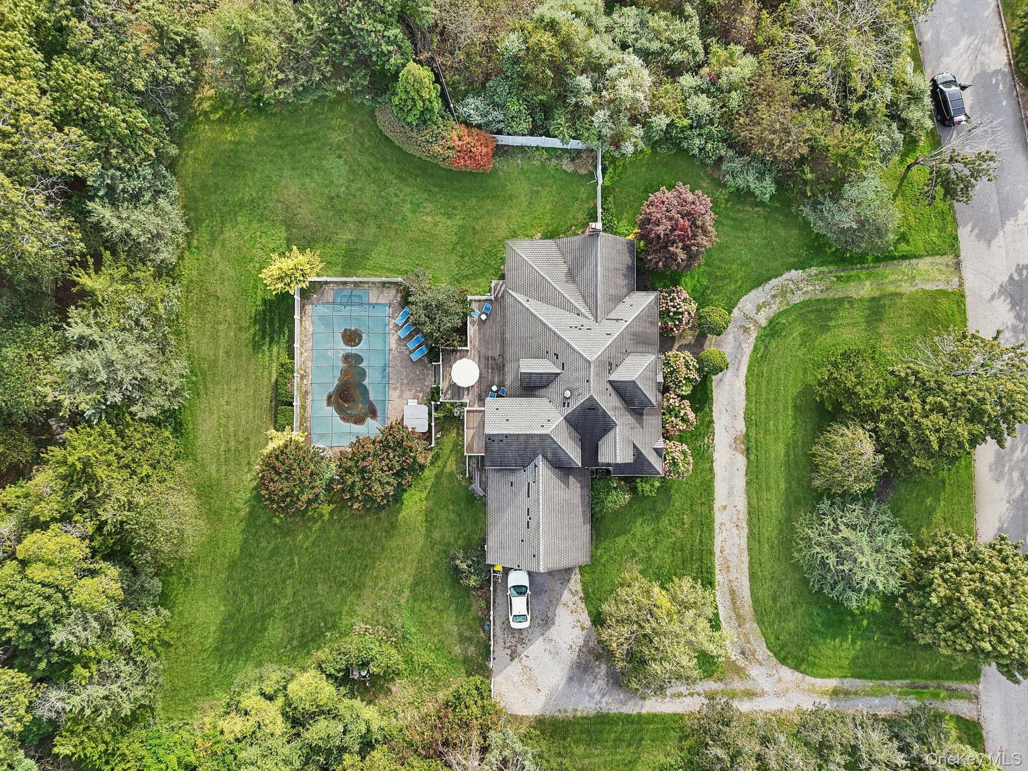 12 Laila Lane Remsenburg, NY 11960 - Photo 47 of 49 an aerial view of a house with outdoor space and trees all around