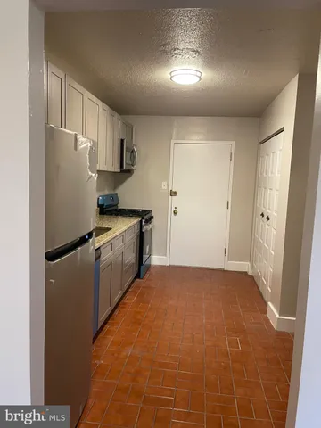 a kitchen with stainless steel appliances a refrigerator and a stove