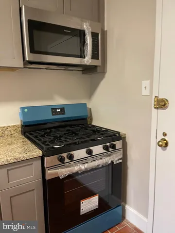 a stove top oven sitting inside of a kitchen