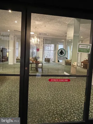 a bathroom with mirror and shower