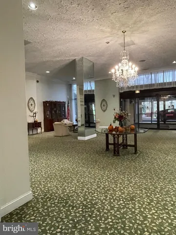 a lobby with furniture and a chandelier