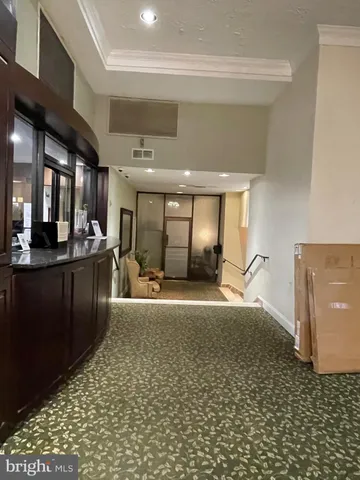 a living room with stainless steel appliances kitchen island granite countertop a sink and cabinets