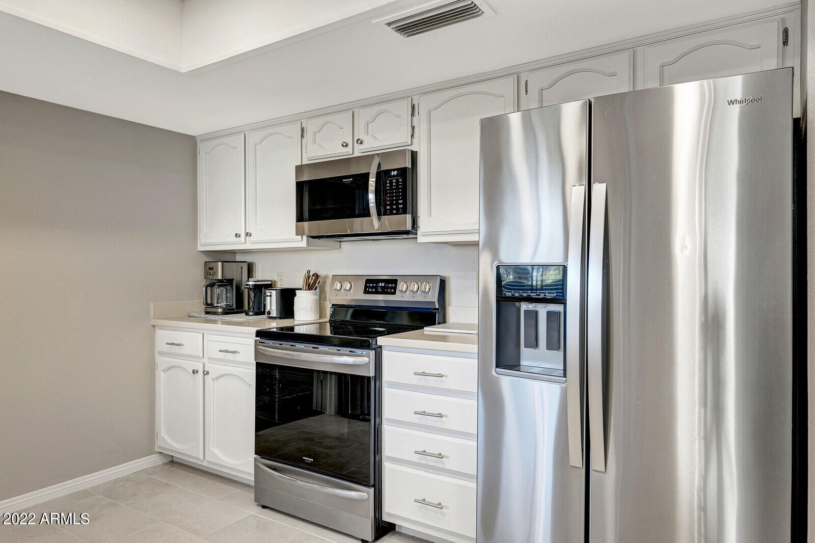 18425 East 4 Peaks Boulevard Rio Verde, AZ 85263 - Photo 15 of 75 a kitchen with stainless steel appliances white cabinets and a refrigerator