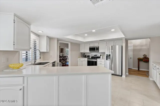 a bedroom with a bed and a dresser with wooden floor