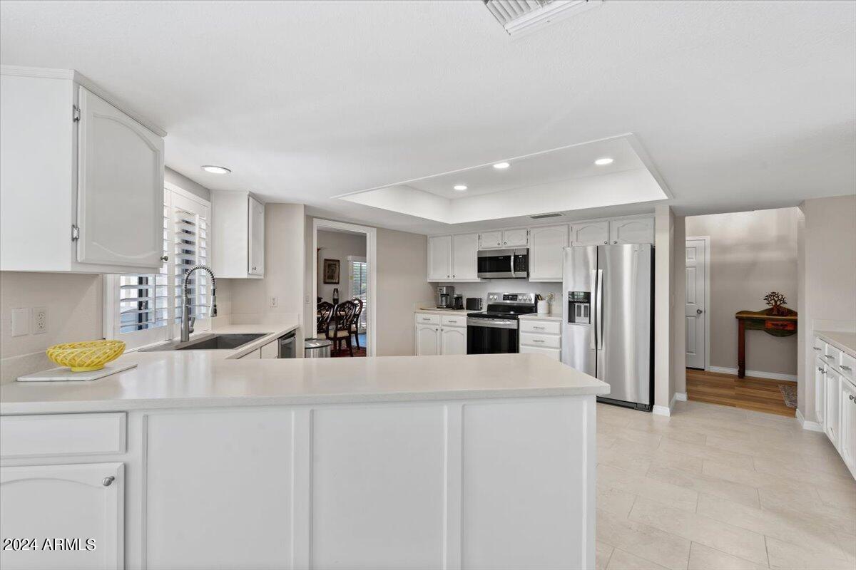 18425 East 4 Peaks Boulevard Rio Verde, AZ 85263 - Photo 16 of 75 a kitchen with stainless steel appliances a refrigerator sink and cabinets