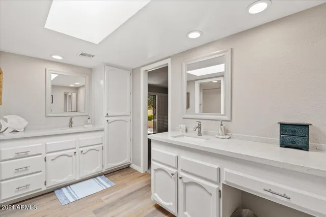 a bathroom with a sink vanity mirror and toilet
