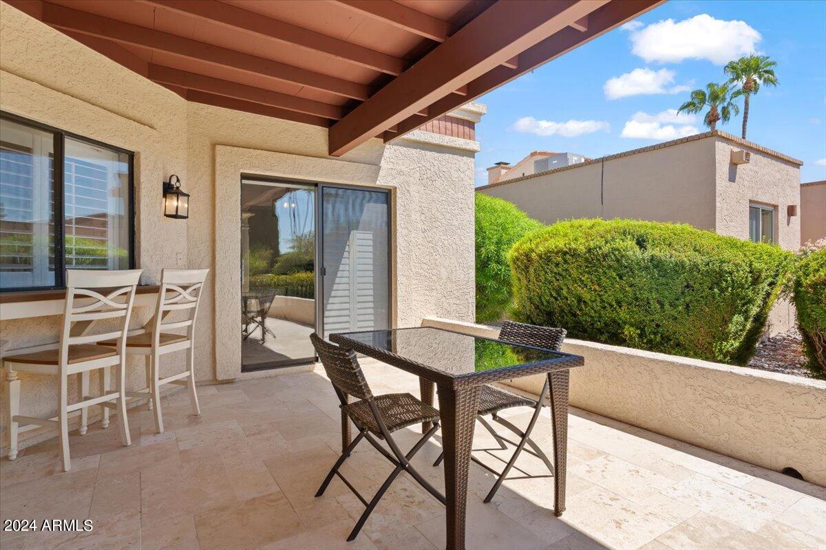 18425 East 4 Peaks Boulevard Rio Verde, AZ 85263 - Photo 39 of 75 a view of a patio with table and chairs and potted plants