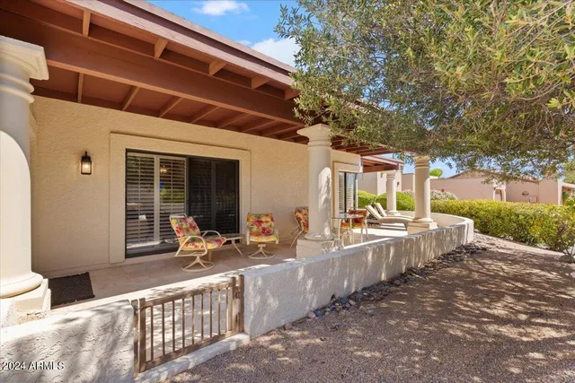 a view of a patio with table and chairs