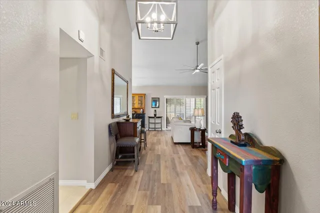 a view of a dining room with furniture a rug and wooden floor
