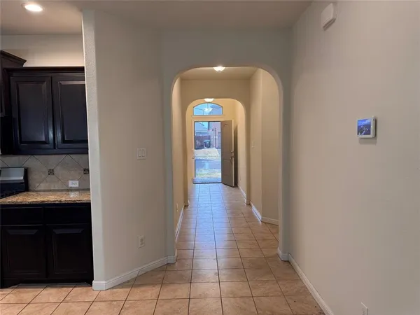 a view of a entryway door with hallway