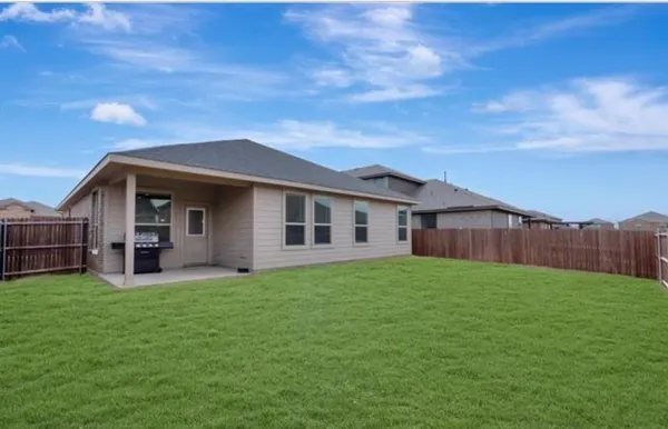 a view of a house with a yard and sitting area