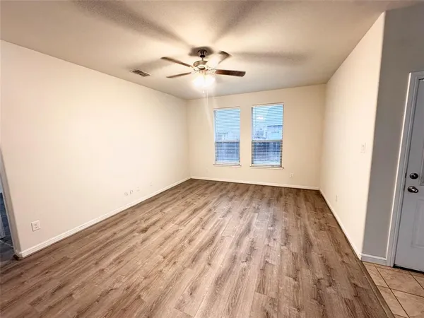 wooden floor in an empty room with a window