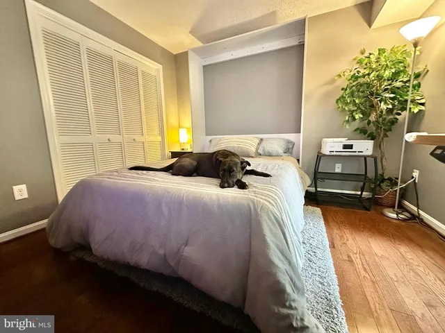 a bedroom with a bed a table and chair