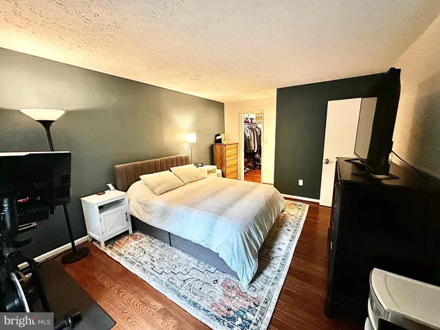 a bed room with a bed and a television