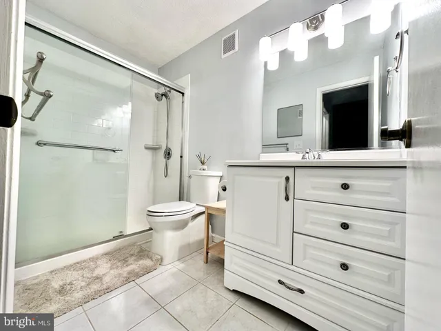 a bathroom with a toilet sink and a mirror