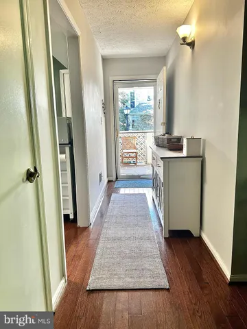 a view of a kitchen from the hallway