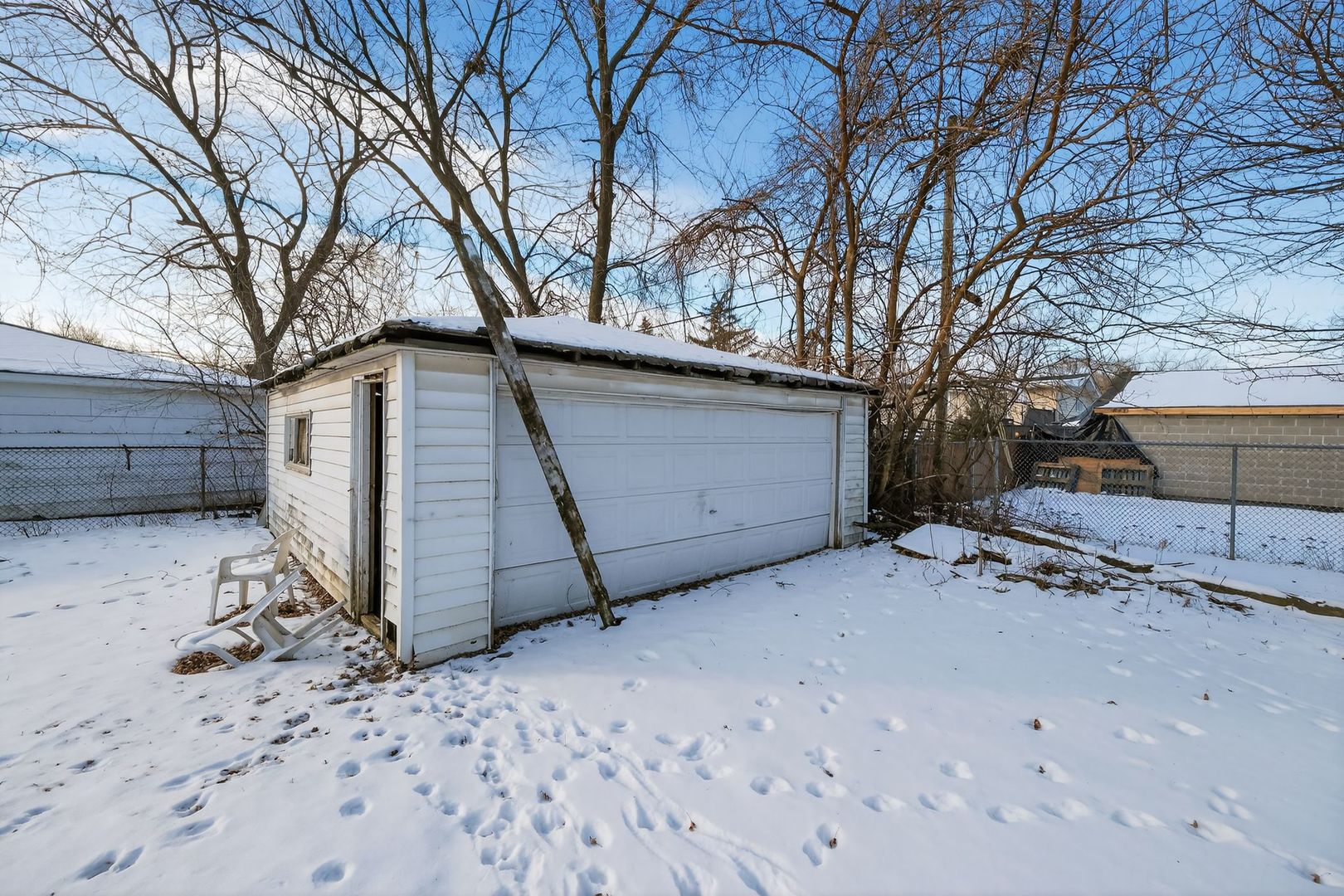 2711 West 165th Street Markham, IL 60428 - Photo 11 of 14 a view of a house with a snow in the yard