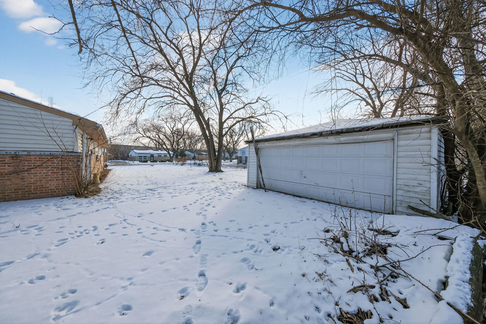 2711 West 165th Street Markham, IL 60428 - Photo 13 of 14 a backyard of a house with large trees