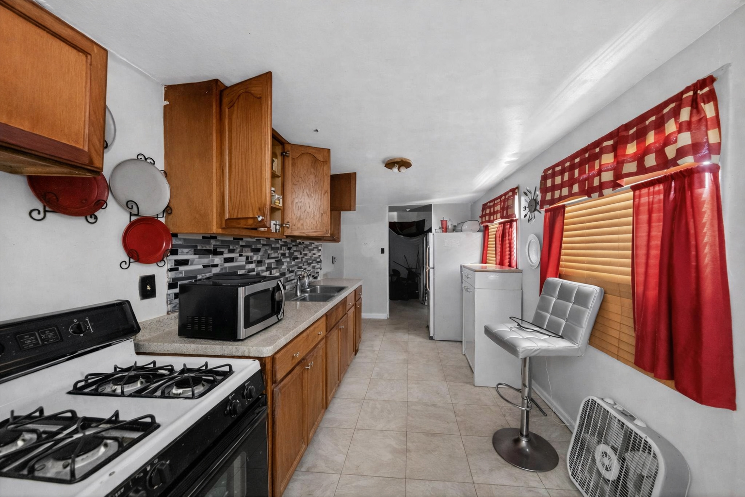 2711 West 165th Street Markham, IL 60428 - Photo 2 of 14 a kitchen with a stove and a wooden floor