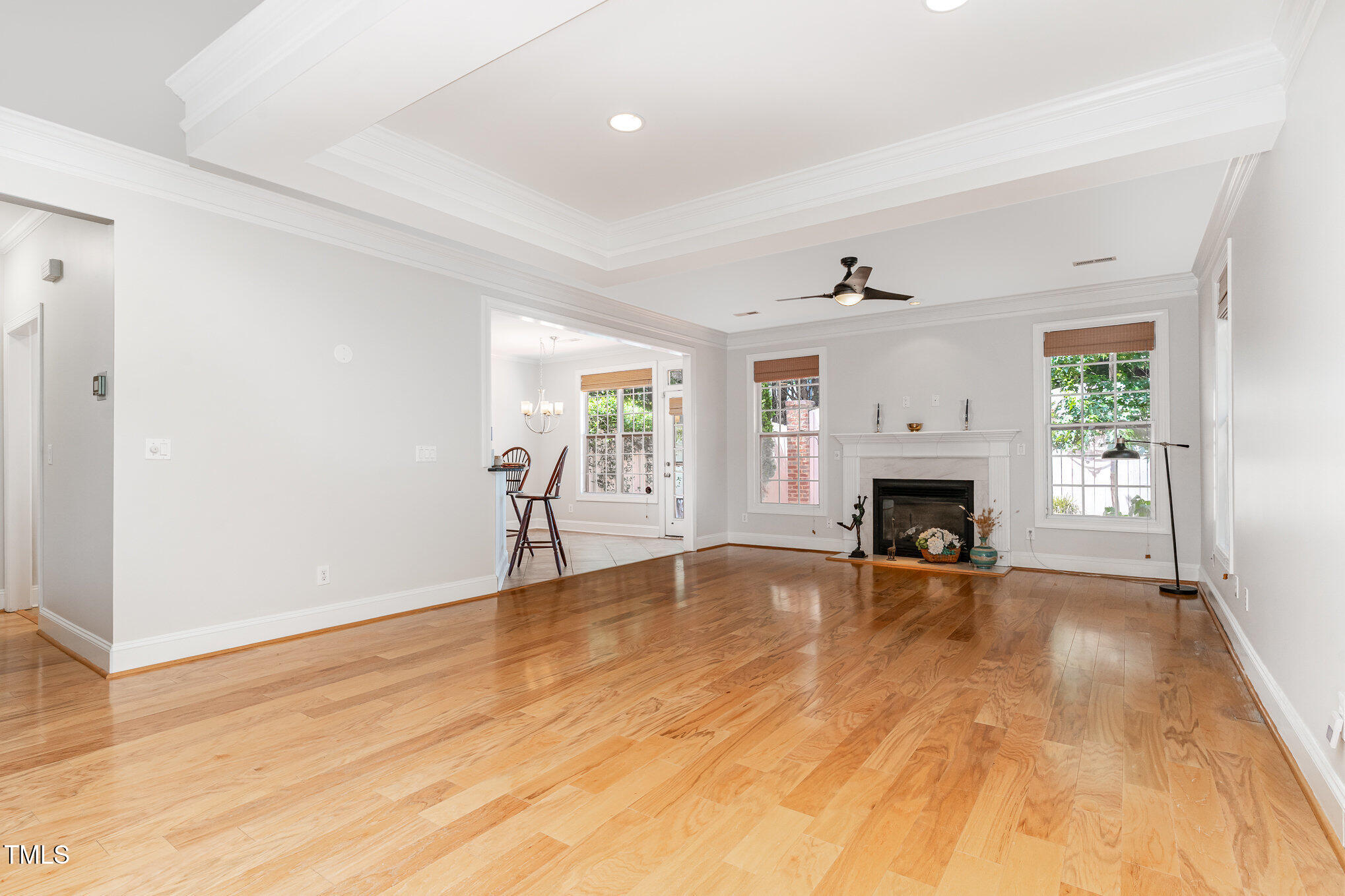 4060 Barton Park Place Raleigh, NC 27613 - Photo 8 of 38 an empty room with wooden floor fireplace and windows