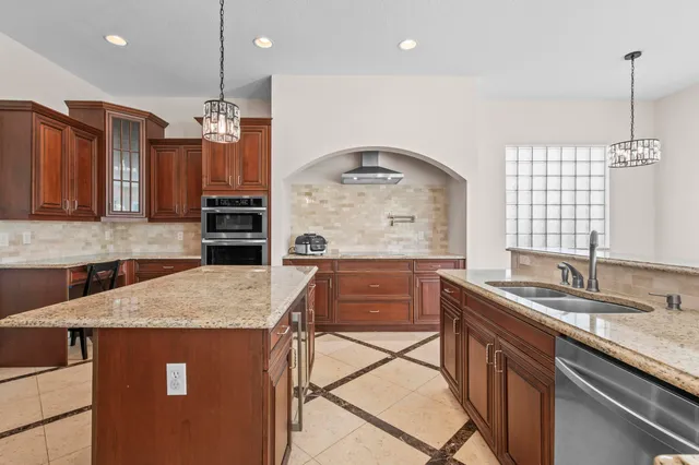 a large bathroom with a granite countertop tub sink shower and mirror