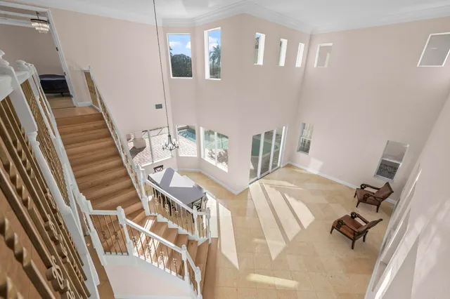 a view of a hallway with wooden floor and closet area