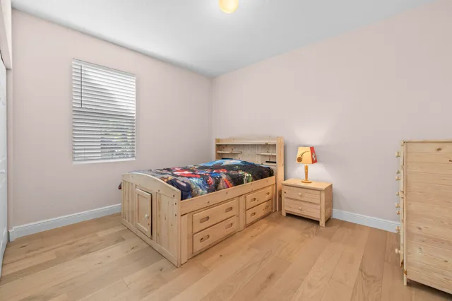 a bedroom with a bed and a dresser