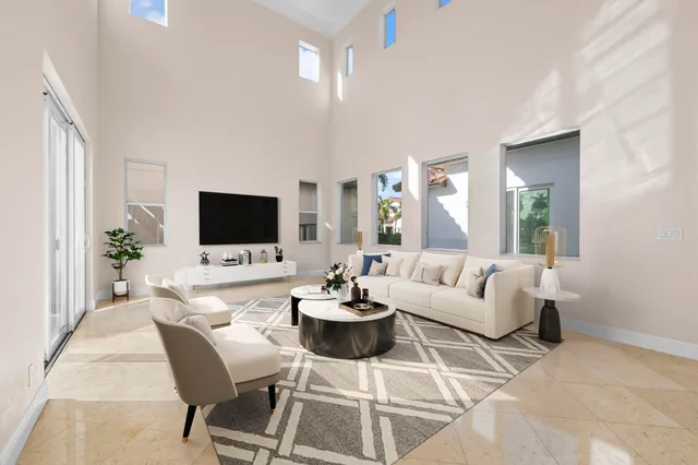 a living room with furniture potted plant and a flat screen tv
