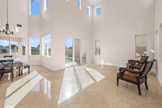 a spacious bedroom with a bed a table and chair