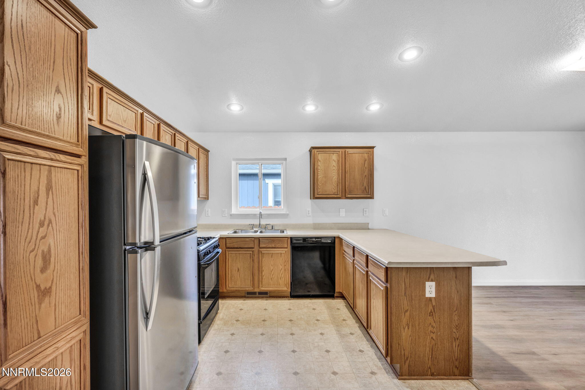 17725 Live Oak Court Reno, NV 89508 - Photo 26 of 44 a kitchen with stainless steel appliances granite countertop a refrigerator a stove and a sink