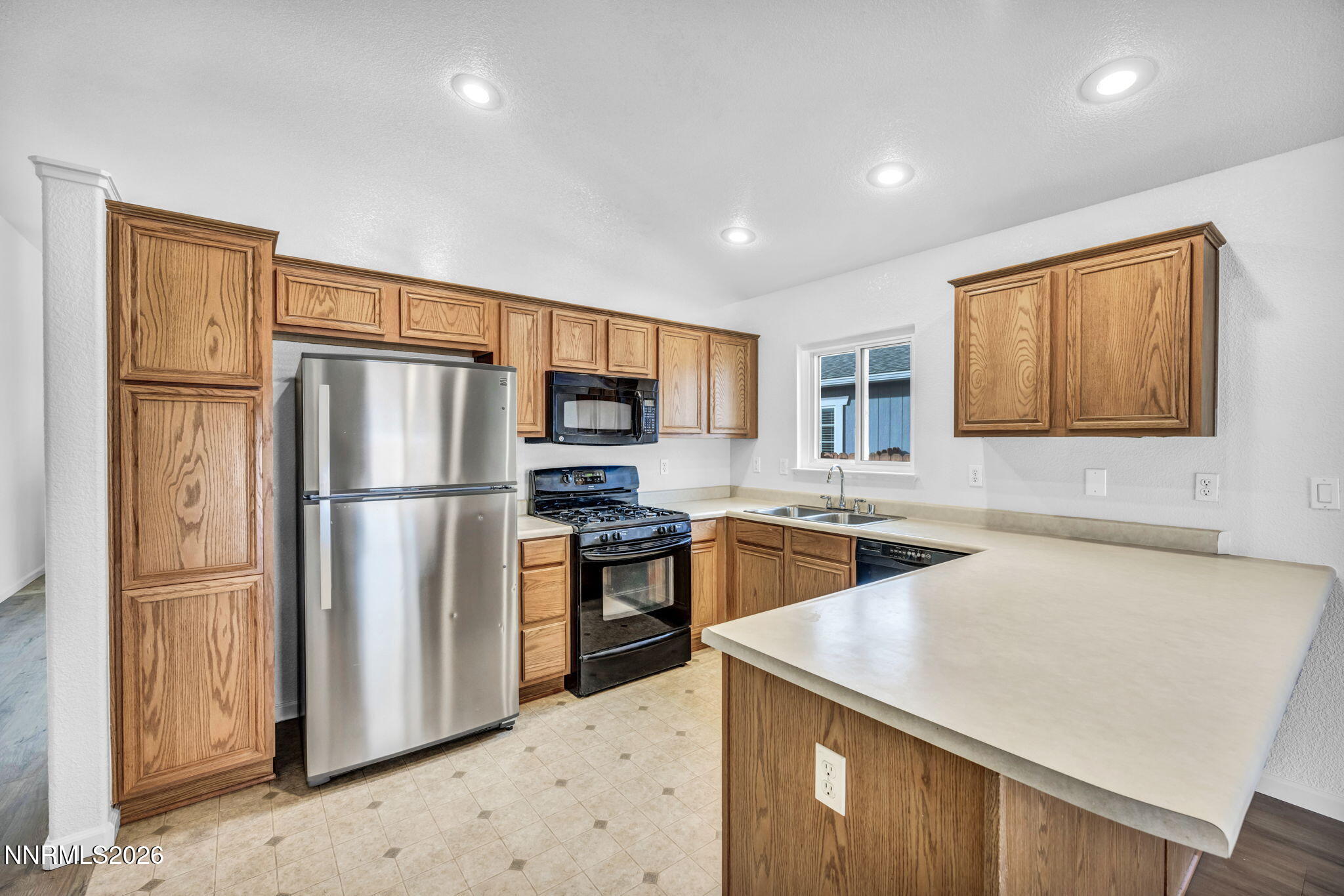 17725 Live Oak Court Reno, NV 89508 - Photo 27 of 44 a kitchen with stainless steel appliances granite countertop a refrigerator a stove a sink a refrigerator white cabinets and wooden floor