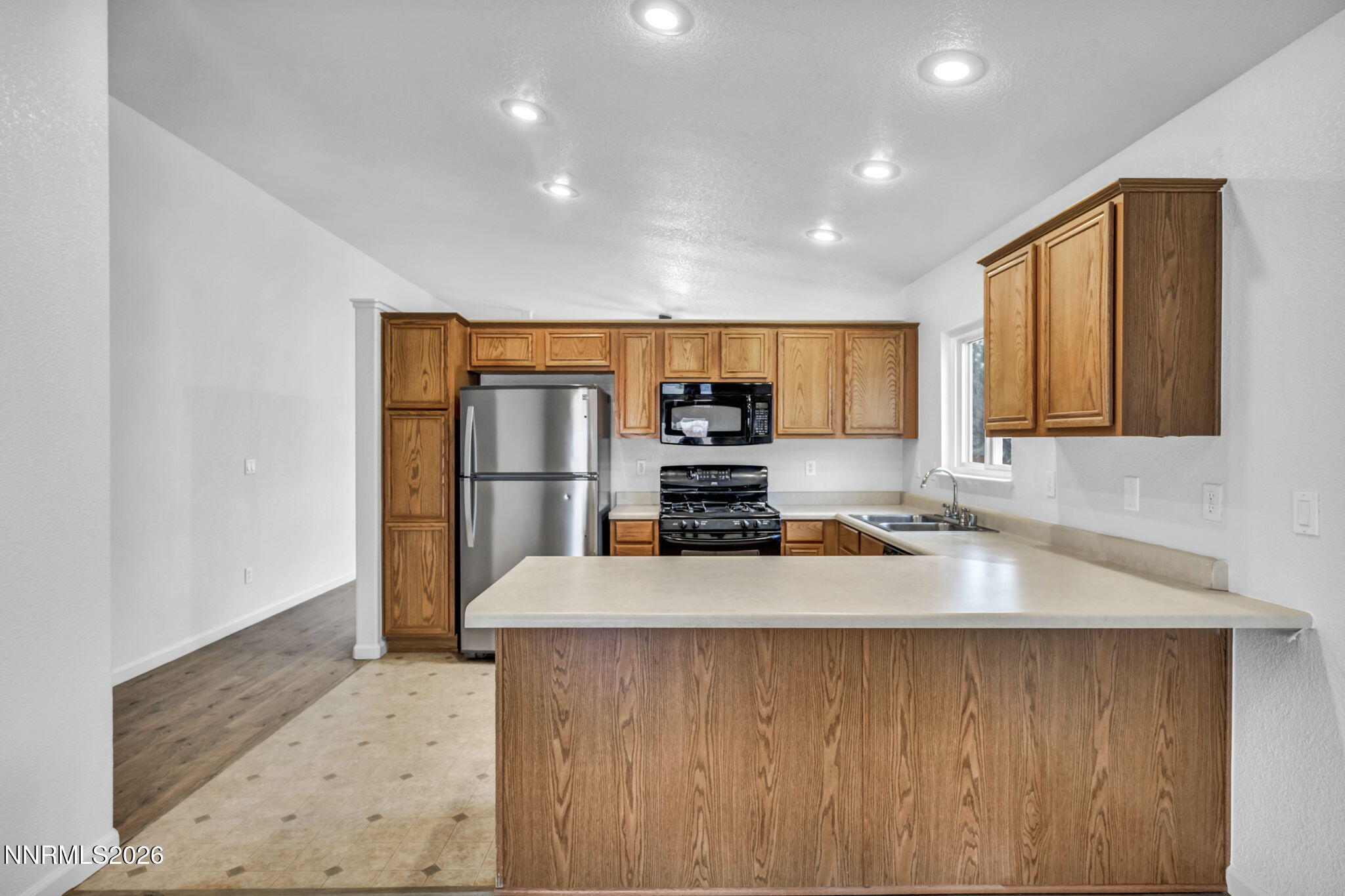 17725 Live Oak Court Reno, NV 89508 - Photo 29 of 44 a large kitchen with stainless steel appliances a large counter top a stove a sink and a refrigerator
