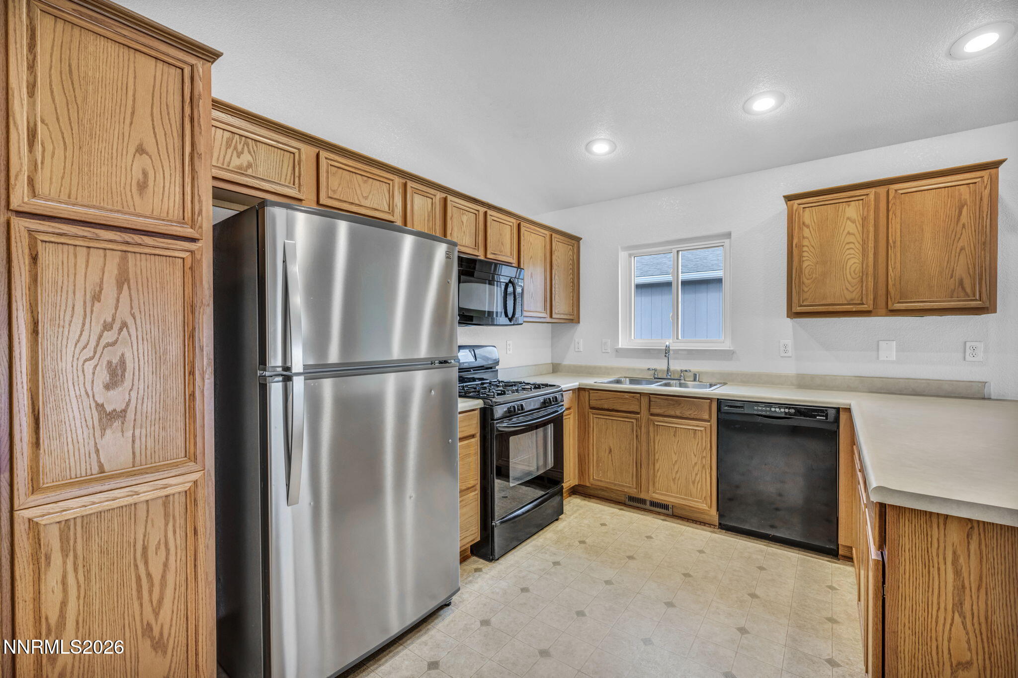 17725 Live Oak Court Reno, NV 89508 - Photo 31 of 44 a kitchen with stainless steel appliances granite countertop a refrigerator sink and stove