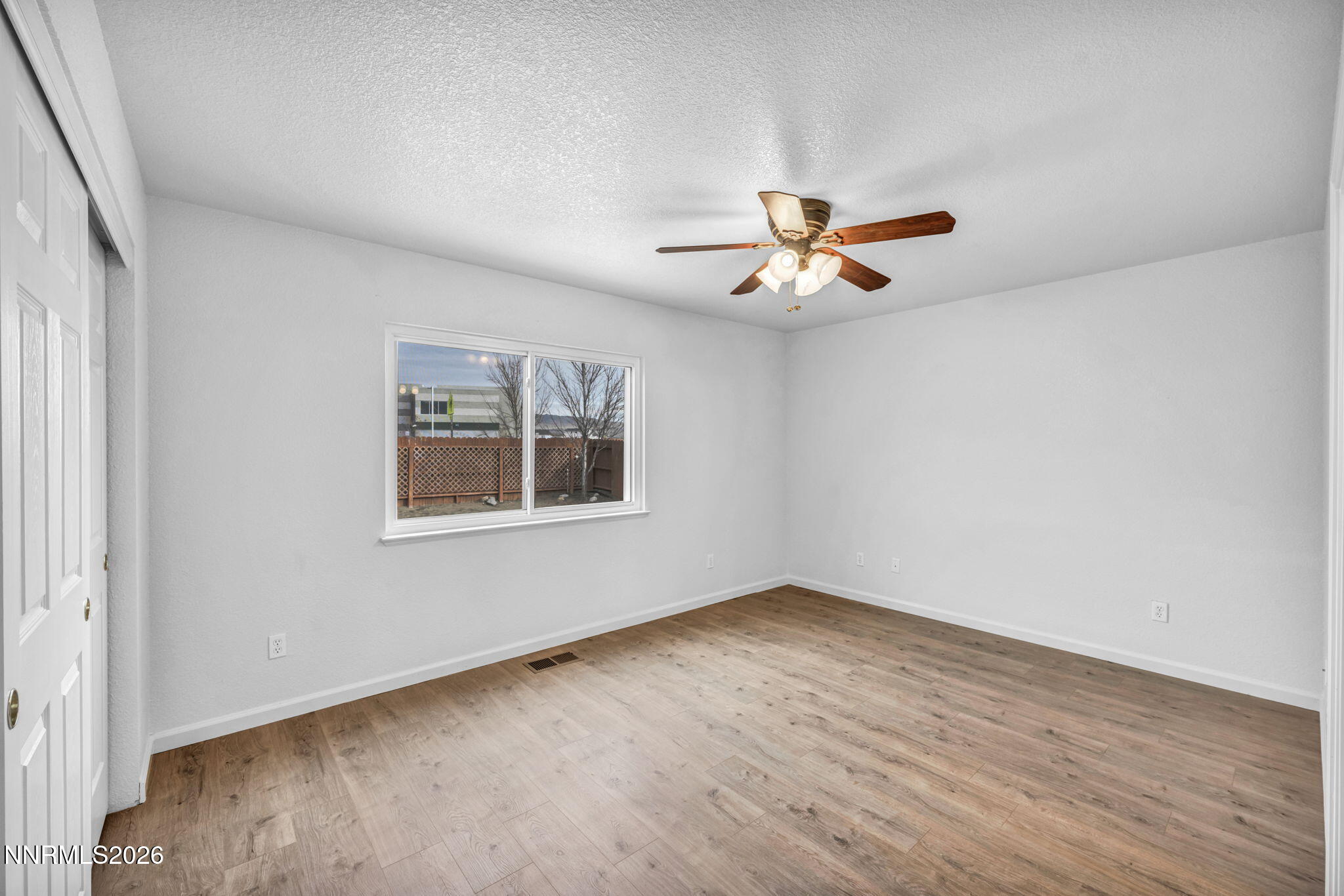 17725 Live Oak Court Reno, NV 89508 - Photo 32 of 44 an empty room with a window and a fan
